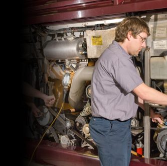 Service techs doing maintenance on bus